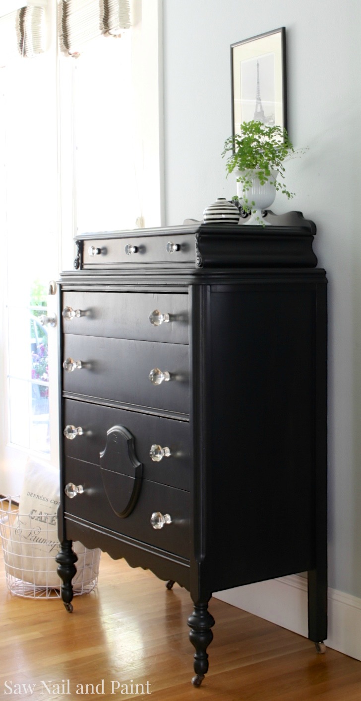 black dresser with glass drawers