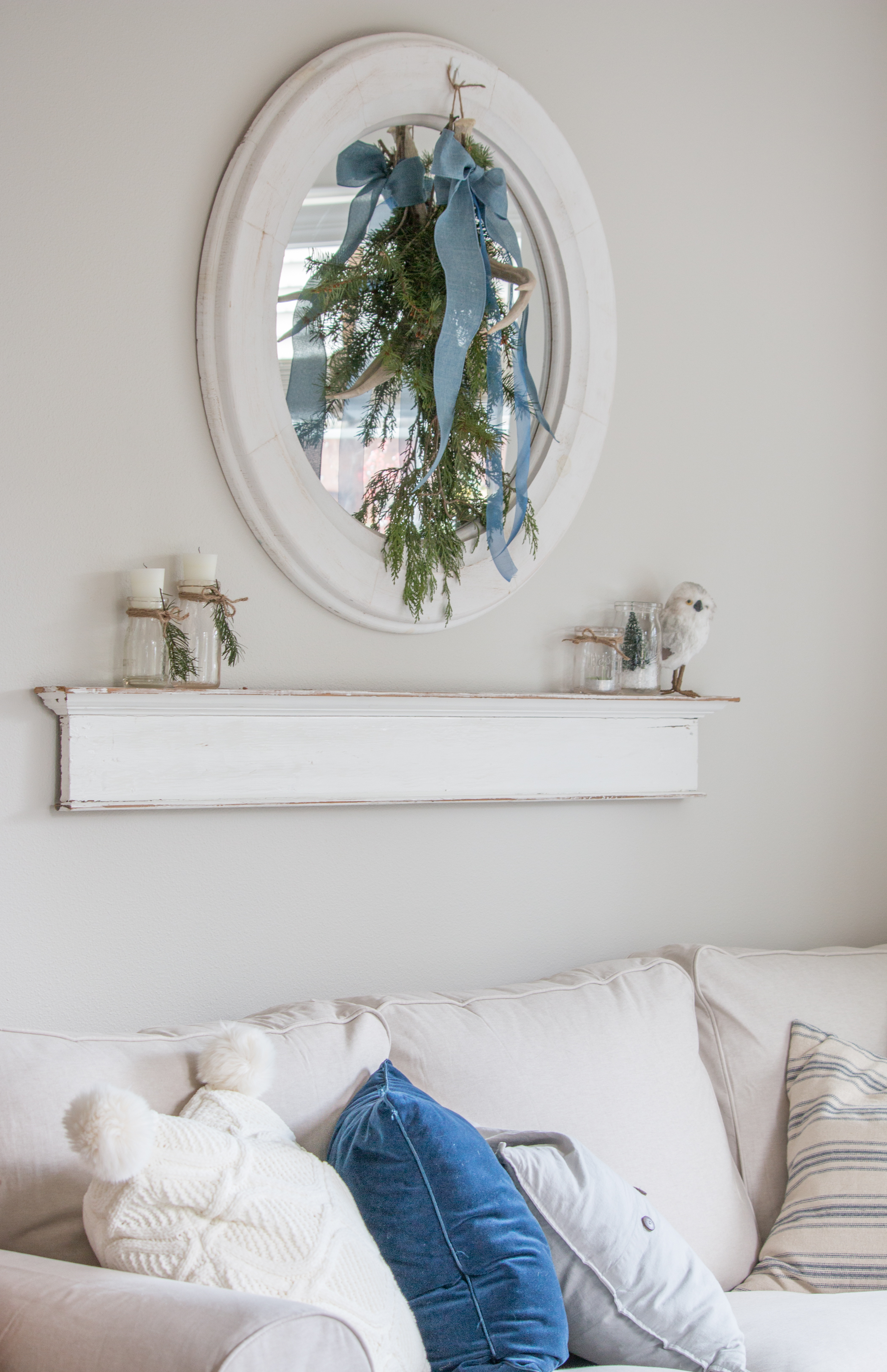 Round white mirror with vintage milk bottle candles - Saw Nail and Paint